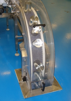 Cans being held in position on the conveyor by magnets